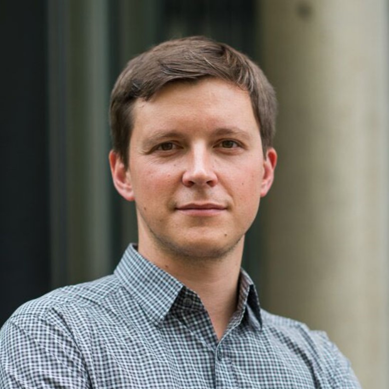 Andres is a caucasian man white brown hair and eyes. He is wearing a checkered-collared shirt.